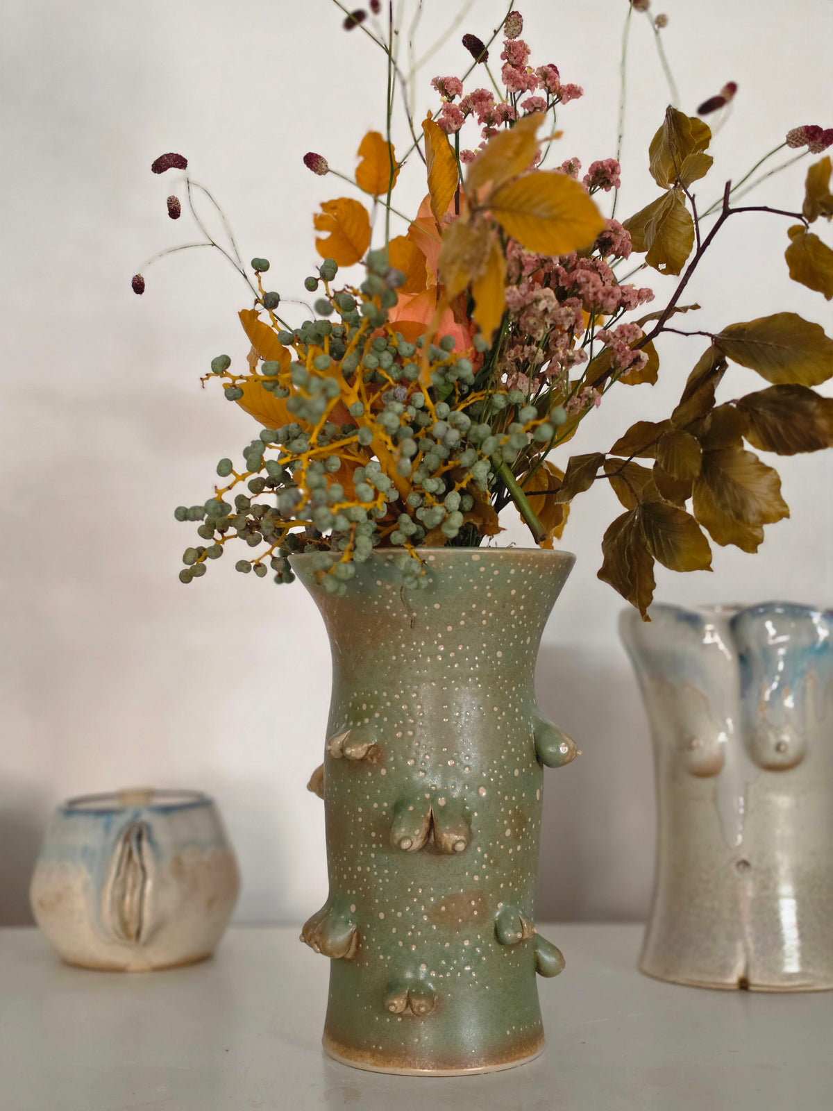 Titty vase, front, with dried flowers